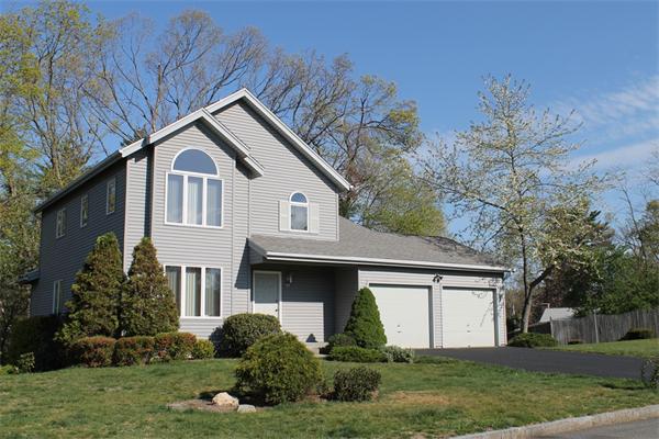 61 Stephanie Circle Springfield, MA 01129 - Photo 1 of 16 a front view of a house with a yard and trees