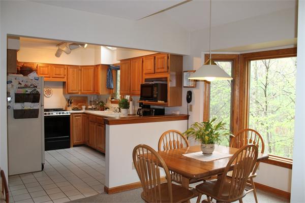 61 Stephanie Circle Springfield, MA 01129 - Photo 5 of 16 a kitchen with a table chairs refrigerator and microwave