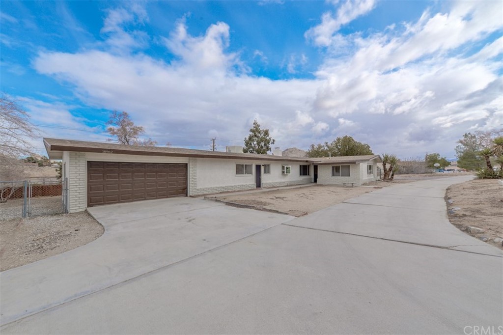 18962 Symeron Road Apple Valley, CA 92307 - Photo 1 of 1 a front view of a house with a yard and garage