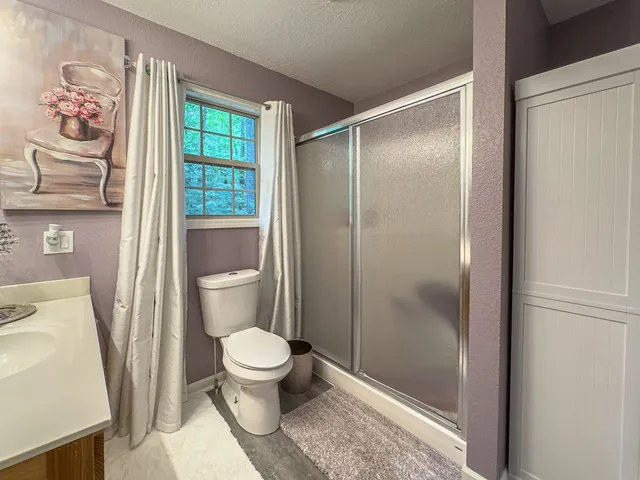 a bathroom with a toilet and a shower