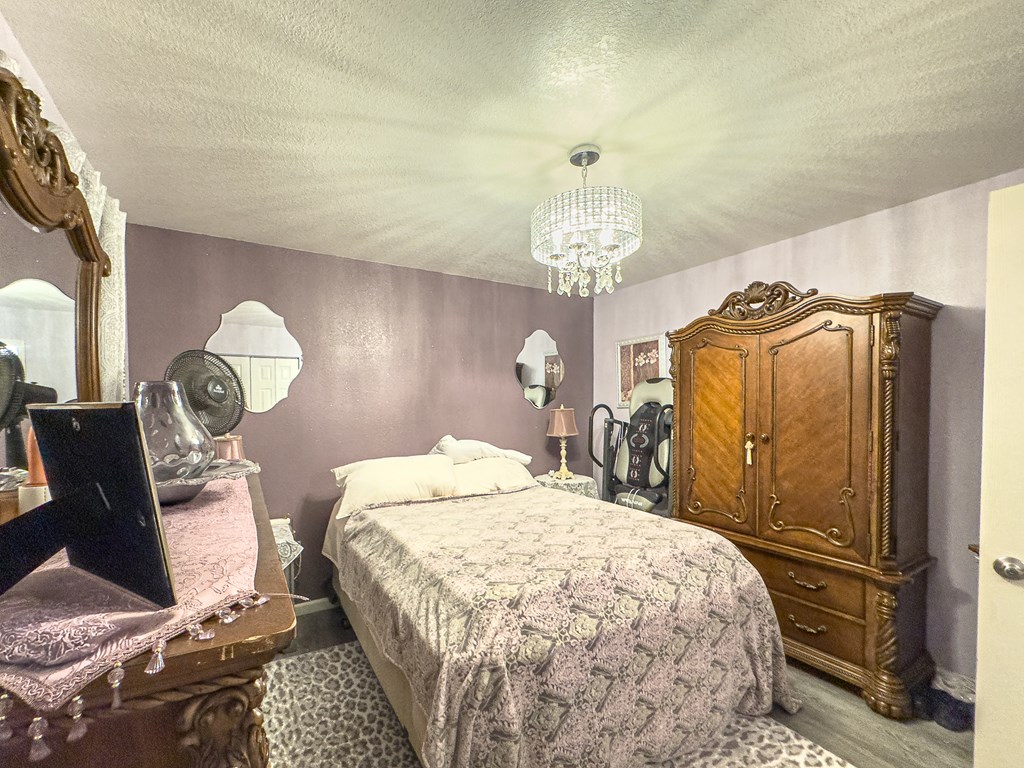 89 Box Turtle Lane Murphy, NC 28906 - Photo 21 of 55 a bedroom with a bed and a chandelier