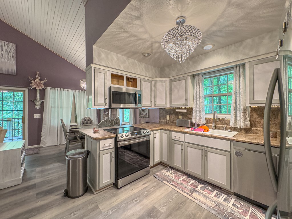 89 Box Turtle Lane Murphy, NC 28906 - Photo 24 of 55 a kitchen with a stove sink and cabinets