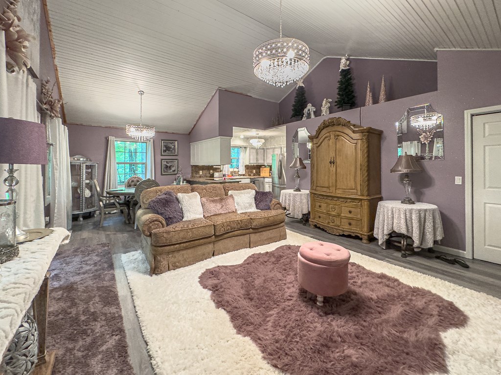 89 Box Turtle Lane Murphy, NC 28906 - Photo 26 of 55 a living room with furniture a chandelier and a dining table