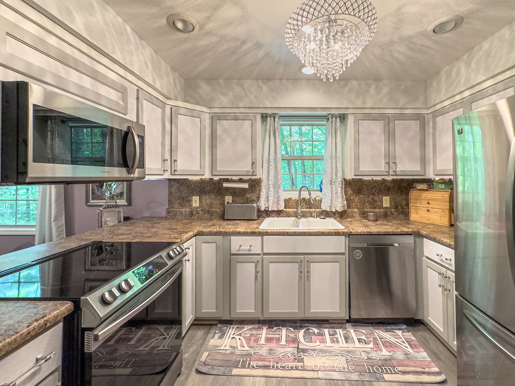 89 Box Turtle Lane Murphy, NC 28906 - Photo 35 of 55 a kitchen with stainless steel appliances granite countertop a sink and a stove