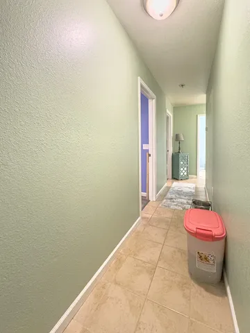 a spacious bedroom with a bed and a chandelier