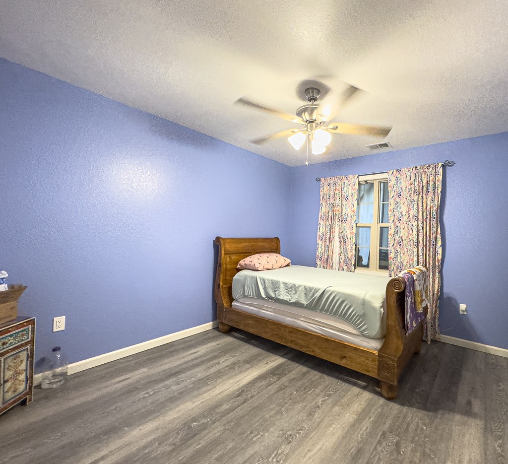 89 Box Turtle Lane Murphy, NC 28906 - Photo 38 of 55 a spacious bedroom with a bed and a chandelier