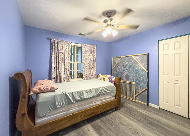 a bedroom with a large bed and a window