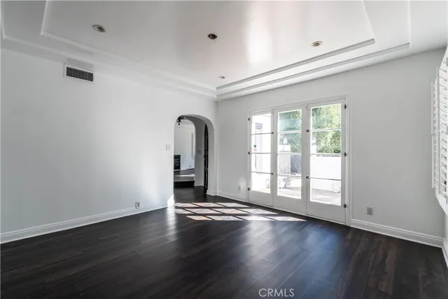 a bathroom with a granite countertop toilet sink and mirror