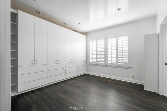 a view of a livingroom with wooden floor and a ceiling fan
