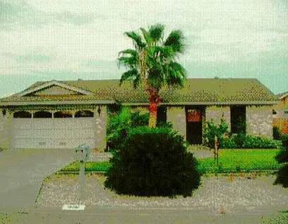 a front view of a house with a garden