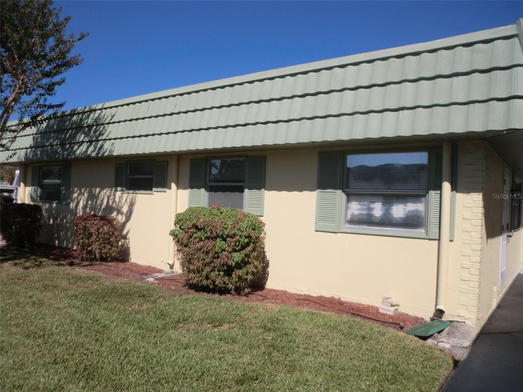 102 Cambridge Trail, Unit 229 Sun City Center, FL 33573 - Photo 18 of 18 a front view of a house with a yard