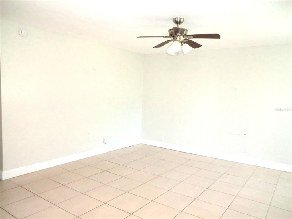 102 Cambridge Trail, Unit 229 Sun City Center, FL 33573 - Photo 2 of 18 a view of a room with a ceiling fan and a window