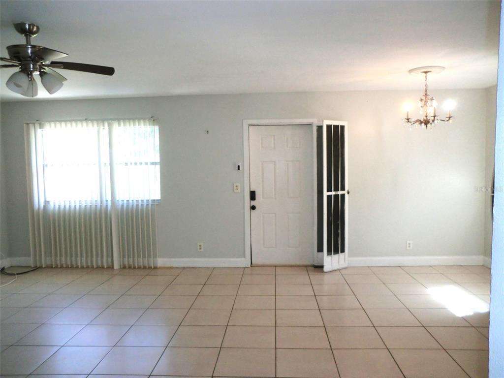 102 Cambridge Trail, Unit 229 Sun City Center, FL 33573 - Photo 4 of 18 an empty room with fan and windows