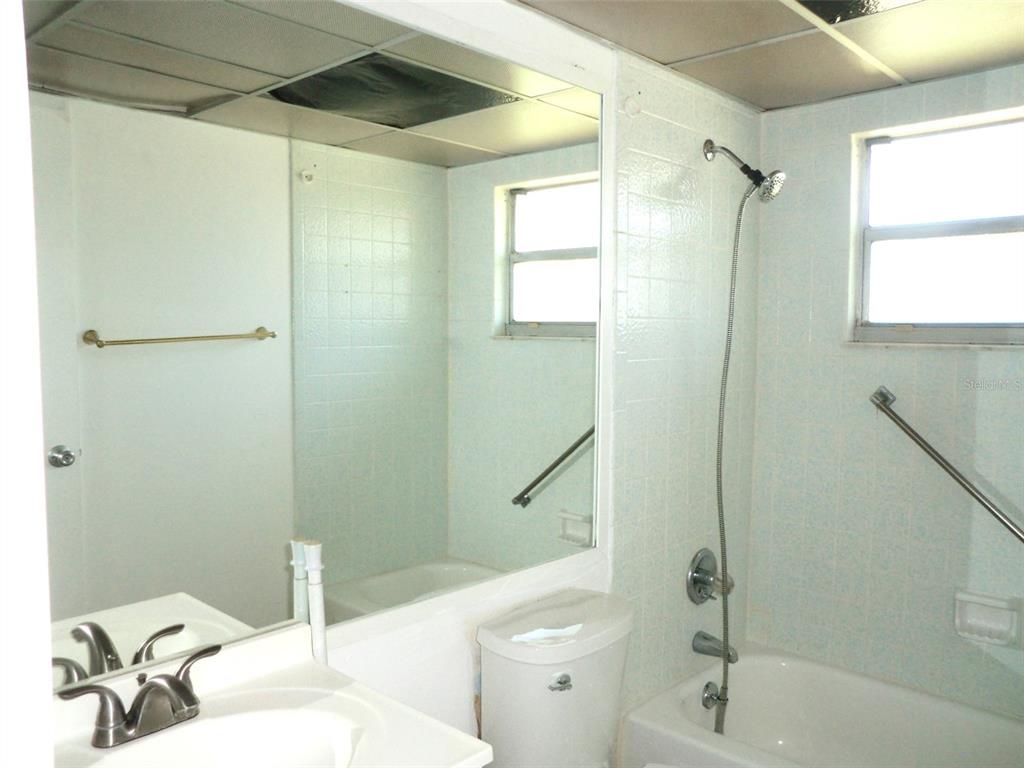 102 Cambridge Trail, Unit 229 Sun City Center, FL 33573 - Photo 8 of 18 a bathroom with a sink a toilet and shower