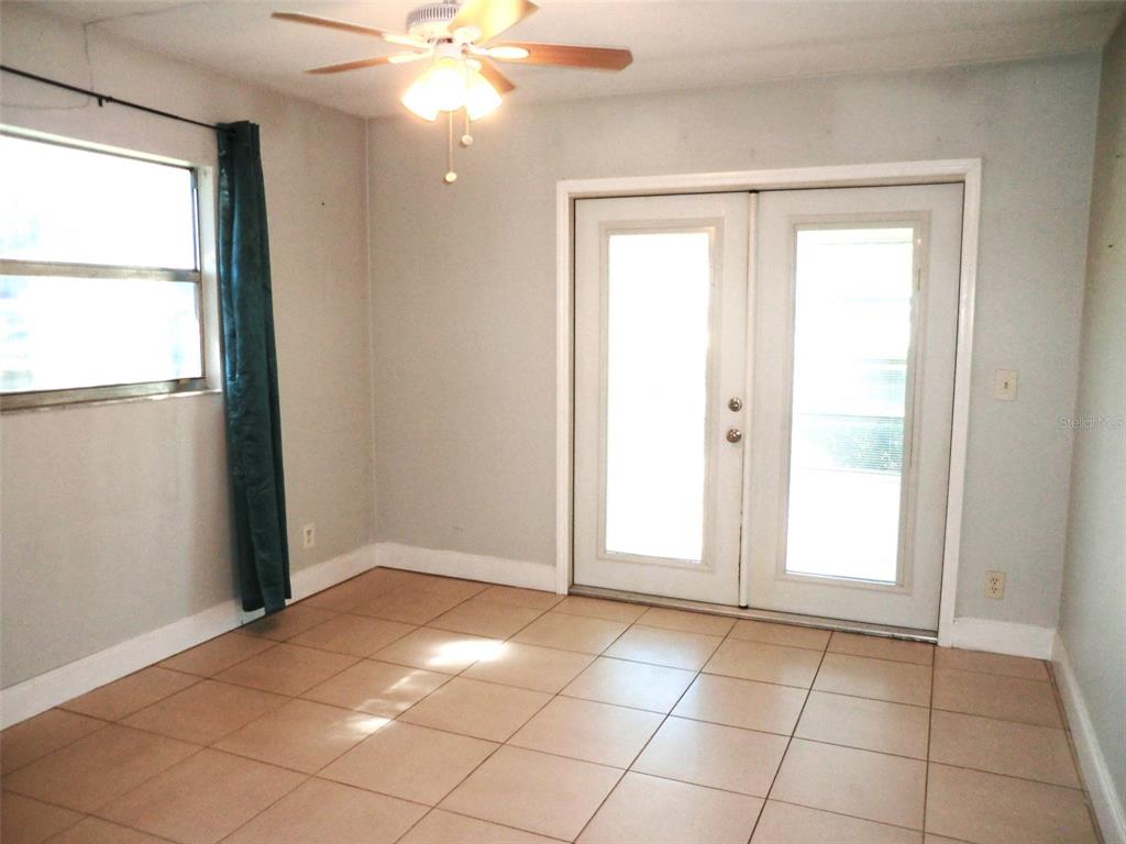 102 Cambridge Trail, Unit 229 Sun City Center, FL 33573 - Photo 9 of 18 an empty room with windows and fan