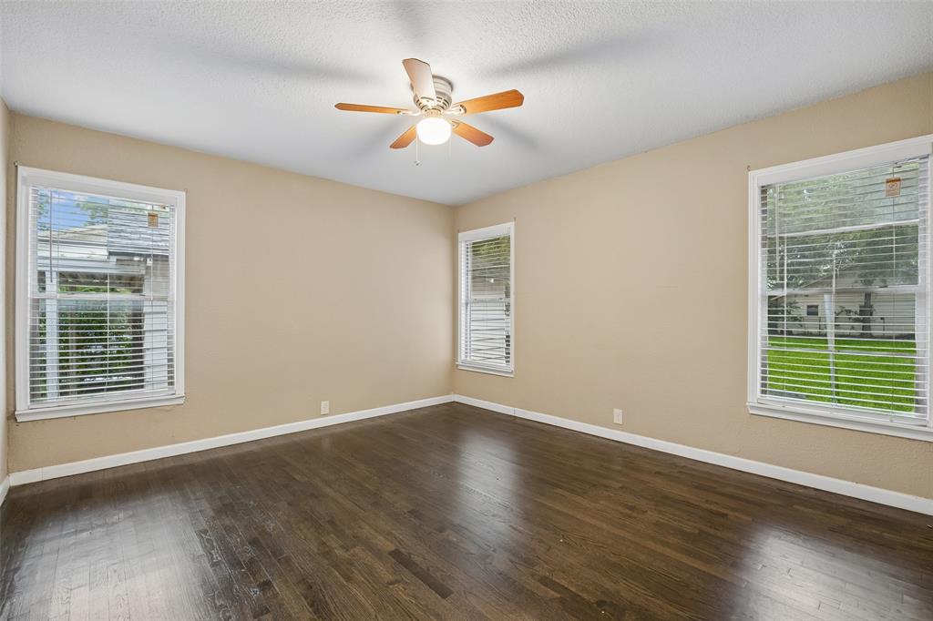 117 Moon Street Cleburne, TX 76033 - Photo 21 of 28 a view of an empty room with wooden floor and a window