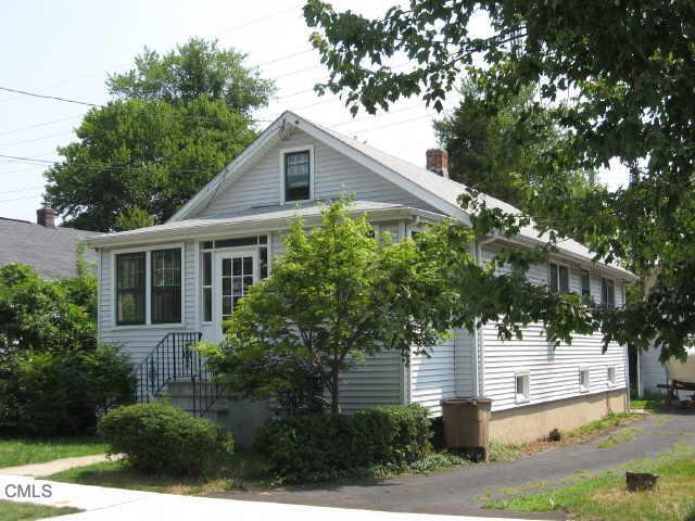 a house that has a tree in front of the house
