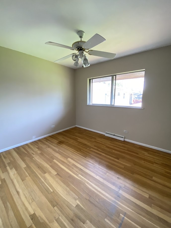 620 Sycamore Road Buffalo Grove, IL 60089 - Photo 11 of 21 an empty room with a window and ceiling fan