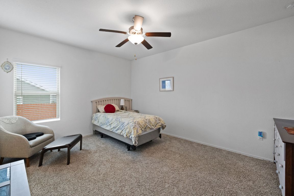 7116 Spirit Hill Road Austin, TX 78744 - Photo 14 of 33 Bedroom with carpet floors and a ceiling fan