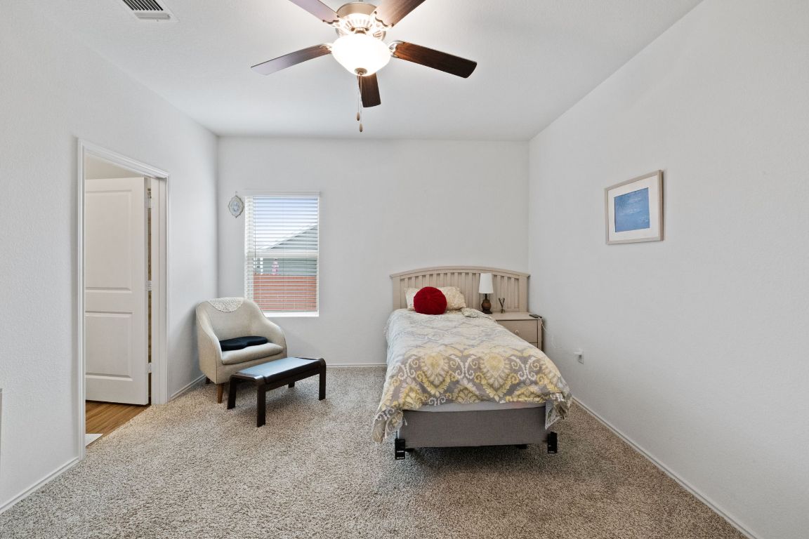 7116 Spirit Hill Road Austin, TX 78744 - Photo 15 of 33 Bedroom with carpet flooring and a ceiling fan