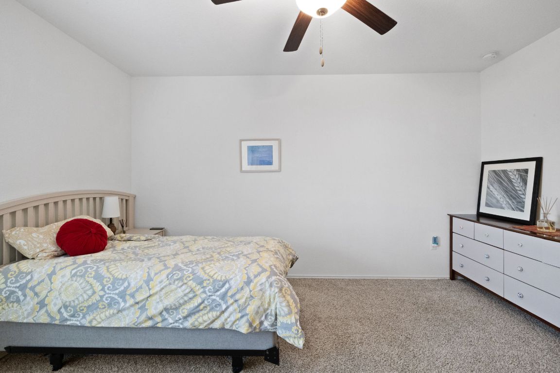 7116 Spirit Hill Road Austin, TX 78744 - Photo 21 of 33 Carpeted bedroom with a ceiling fan and baseboards