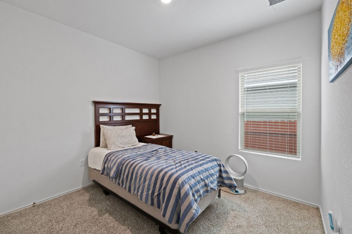 7116 Spirit Hill Road Austin, TX 78744 - Photo 22 of 33 Carpeted bedroom with baseboards
