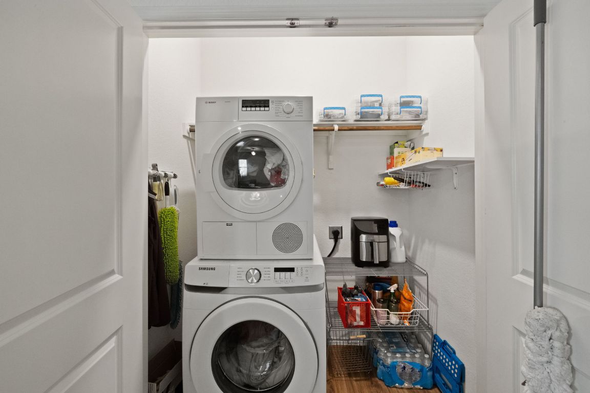 7116 Spirit Hill Road Austin, TX 78744 - Photo 28 of 33 Laundry area with stacked washer and clothes dryer