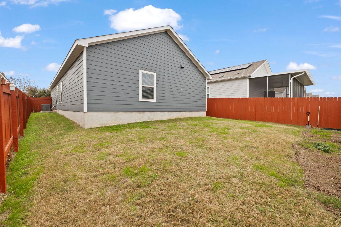 7116 Spirit Hill Road Austin, TX 78744 - Photo 31 of 33 View of property exterior with a fenced backyard
