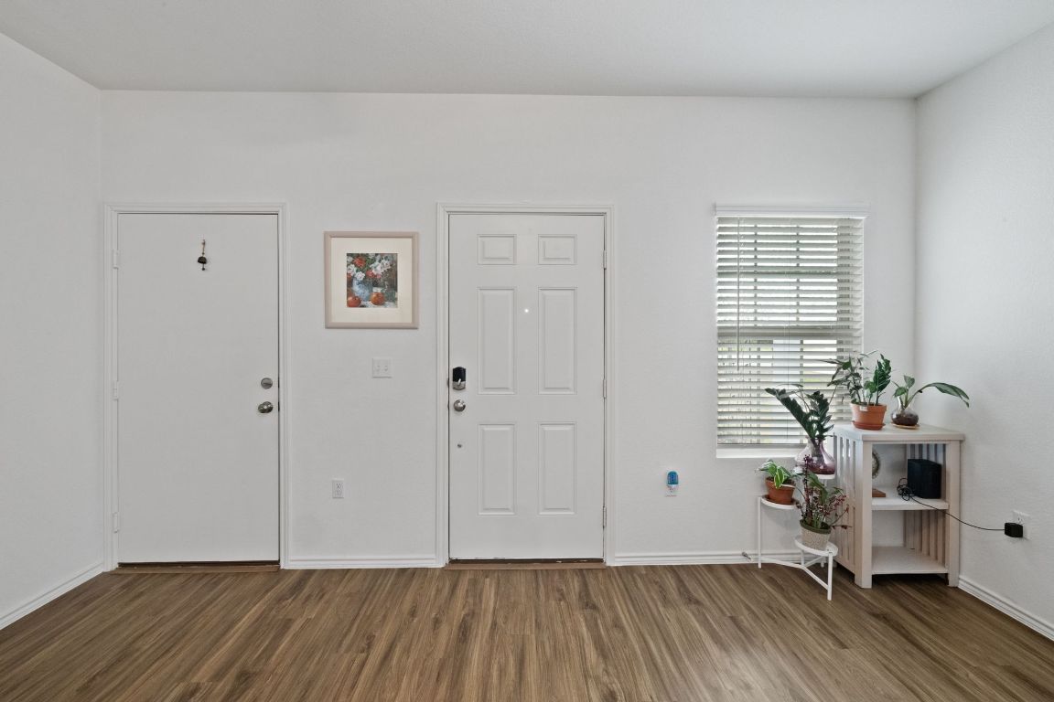 7116 Spirit Hill Road Austin, TX 78744 - Photo 5 of 33 Foyer entrance with dark wood-style floors
