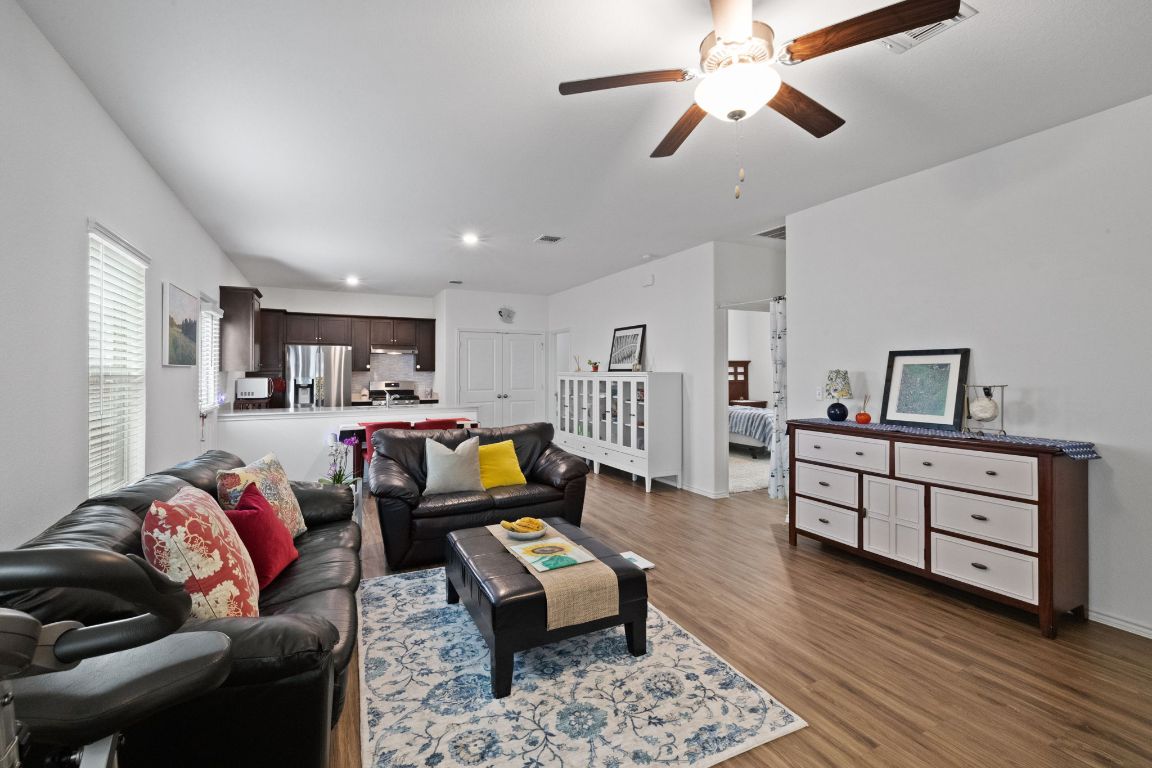 7116 Spirit Hill Road Austin, TX 78744 - Photo 8 of 33 Living area with wood finished floors, a ceiling fan, and recessed lighting