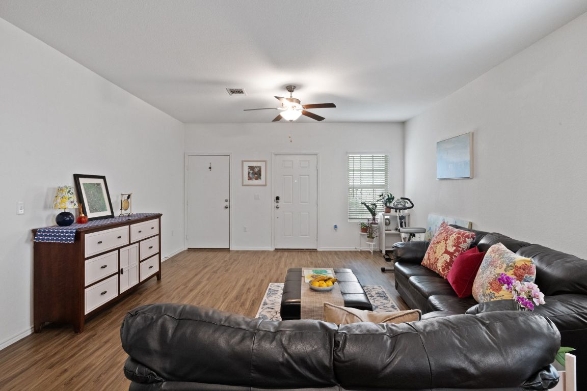 7116 Spirit Hill Road Austin, TX 78744 - Photo 9 of 33 Living area featuring wood finished floors and a ceiling fan