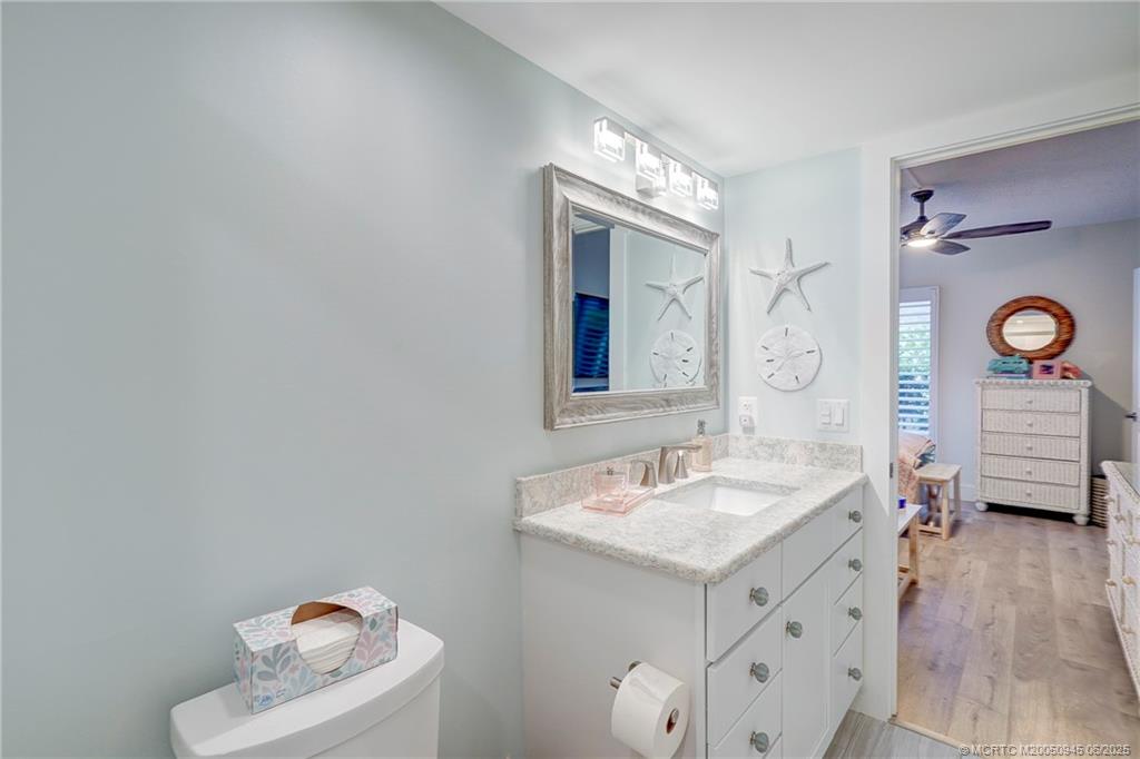 245 Northeast MacArthur Boulevard, Unit 11 Stuart, FL 34996 - Photo 13 of 47 a bathroom with a sink mirror and vanity