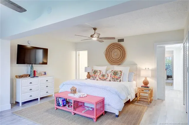 a bedroom with furniture and a flat screen tv