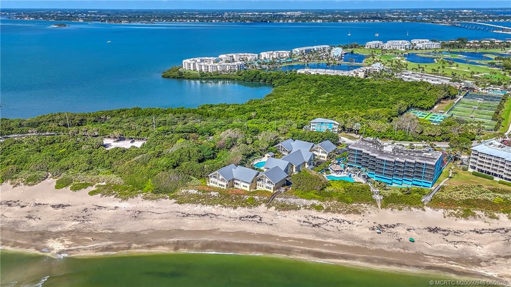 245 Northeast MacArthur Boulevard, Unit 11 Stuart, FL 34996 - Photo 2 of 47 a view of a lake with a city