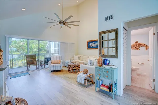 a living room with furniture and a floor to ceiling window