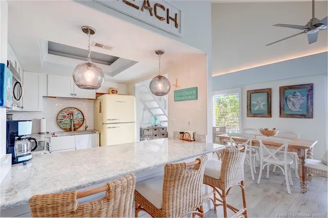 a large kitchen with a table and chairs in it