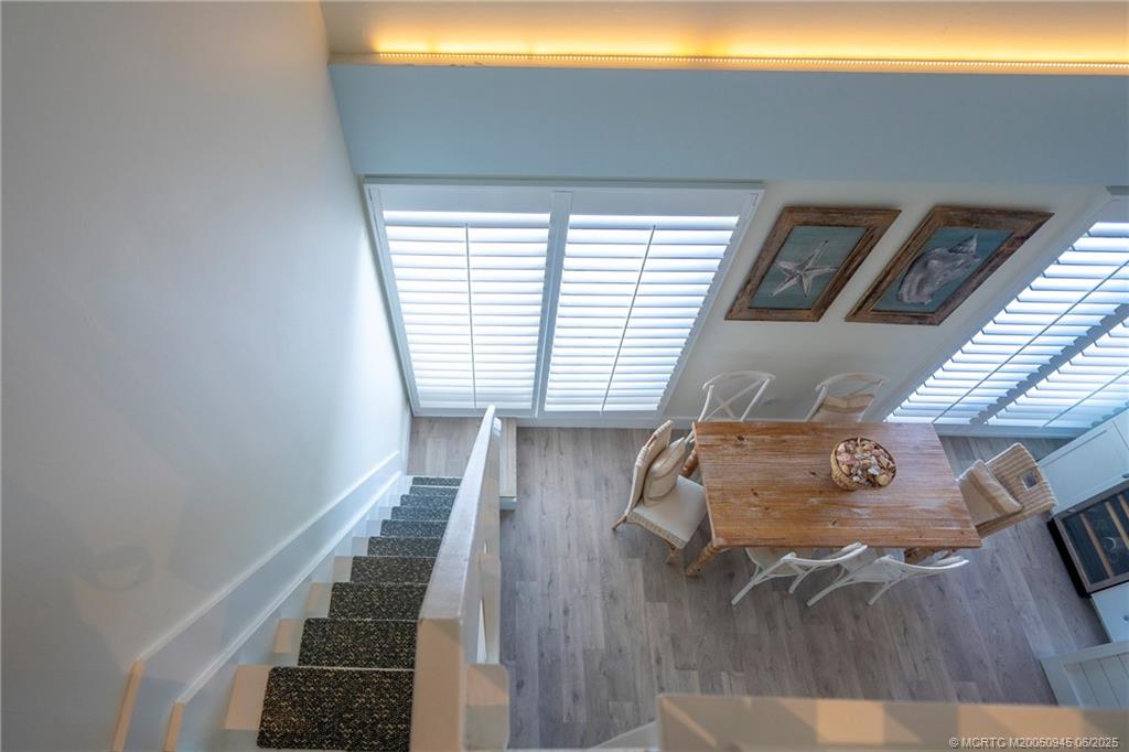 245 Northeast MacArthur Boulevard, Unit 11 Stuart, FL 34996 - Photo 36 of 47 a view of entryway and hall with wooden floor