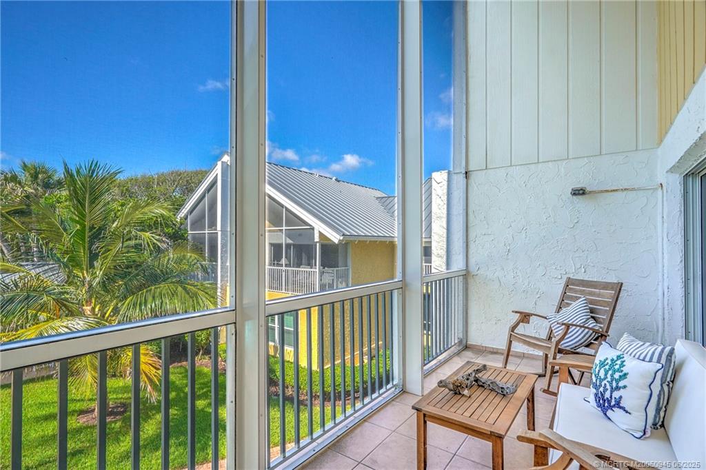 245 Northeast MacArthur Boulevard, Unit 11 Stuart, FL 34996 - Photo 39 of 47 a view of a balcony with furniture