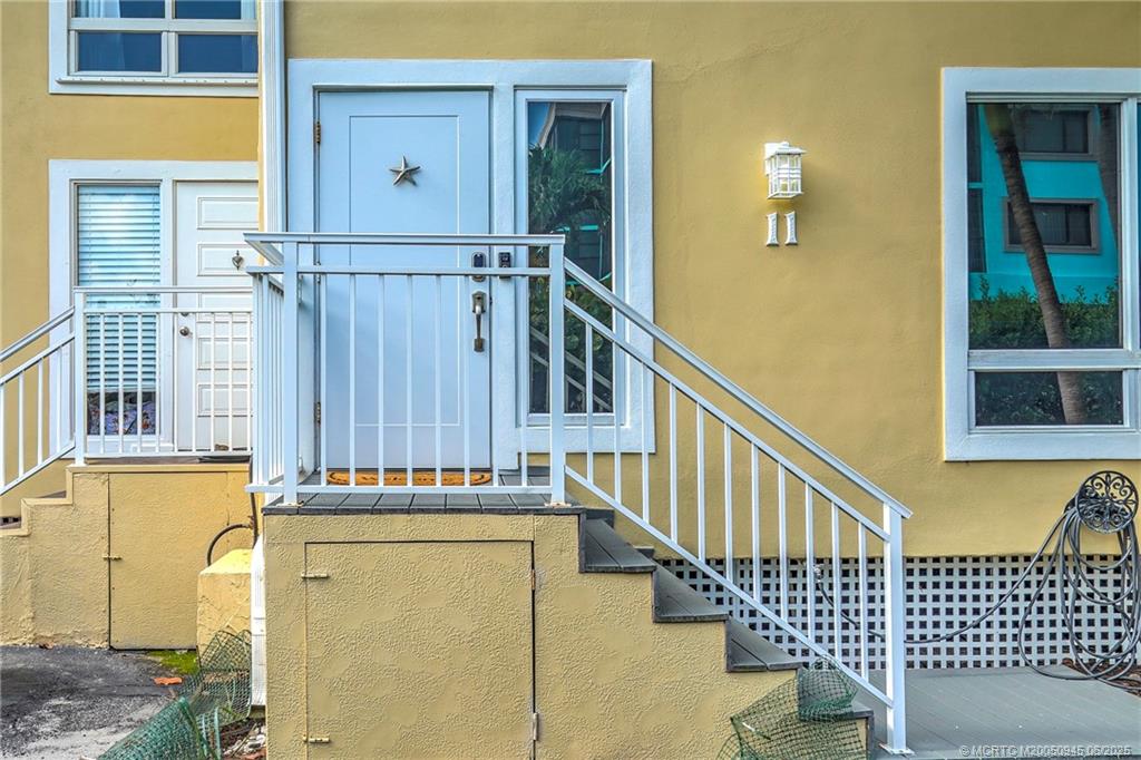 245 Northeast MacArthur Boulevard, Unit 11 Stuart, FL 34996 - Photo 4 of 47 a view of a door with wooden walls