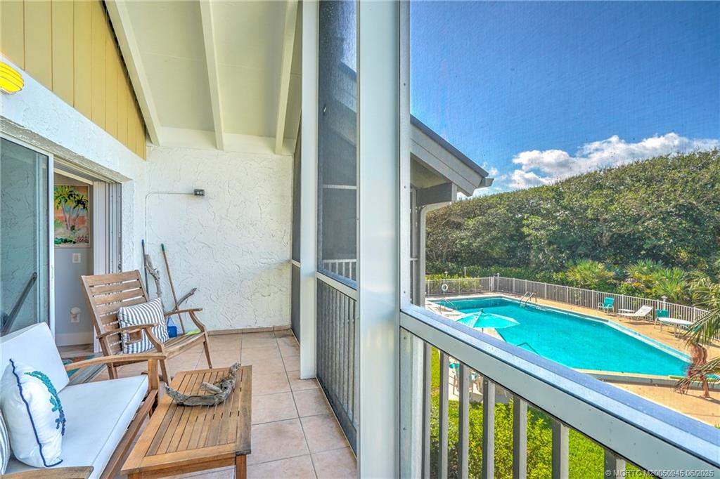 245 Northeast MacArthur Boulevard, Unit 11 Stuart, FL 34996 - Photo 41 of 47 a view of two chairs in balcony