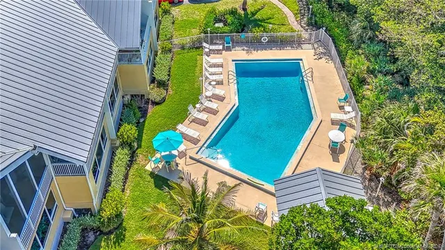 an aerial view of a house with a garden and trees