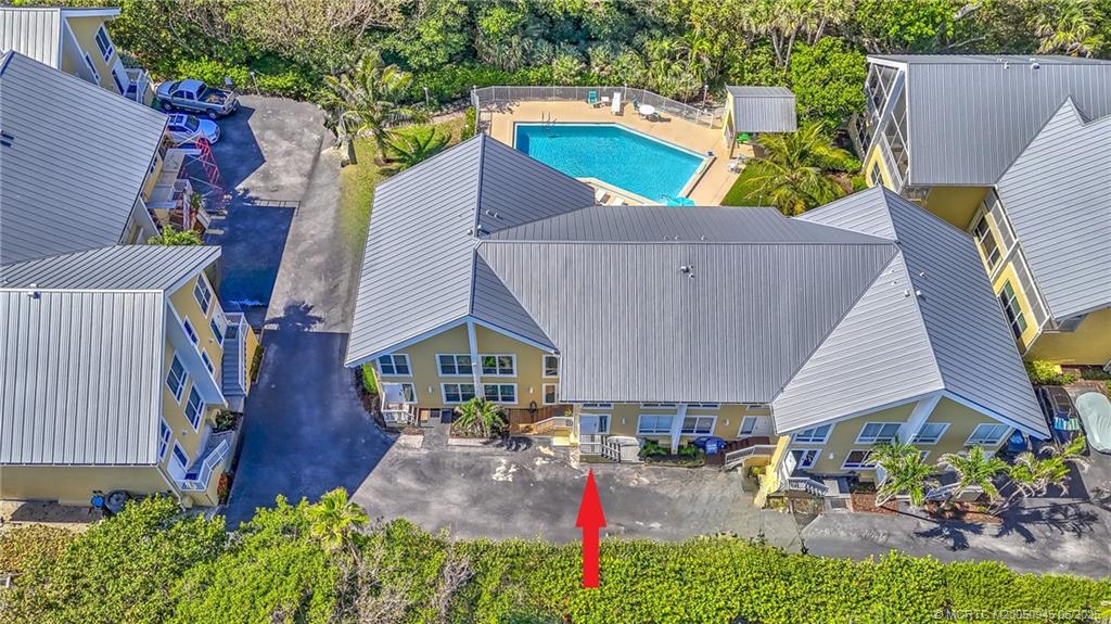 245 Northeast MacArthur Boulevard, Unit 11 Stuart, FL 34996 - Photo 47 of 47 an aerial view of a house with swimming pool and garden