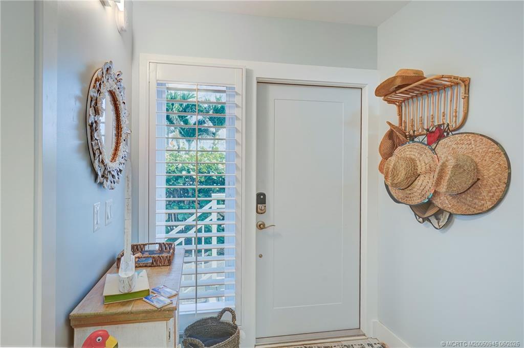 245 Northeast MacArthur Boulevard, Unit 11 Stuart, FL 34996 - Photo 6 of 47 a front view of a house with garden