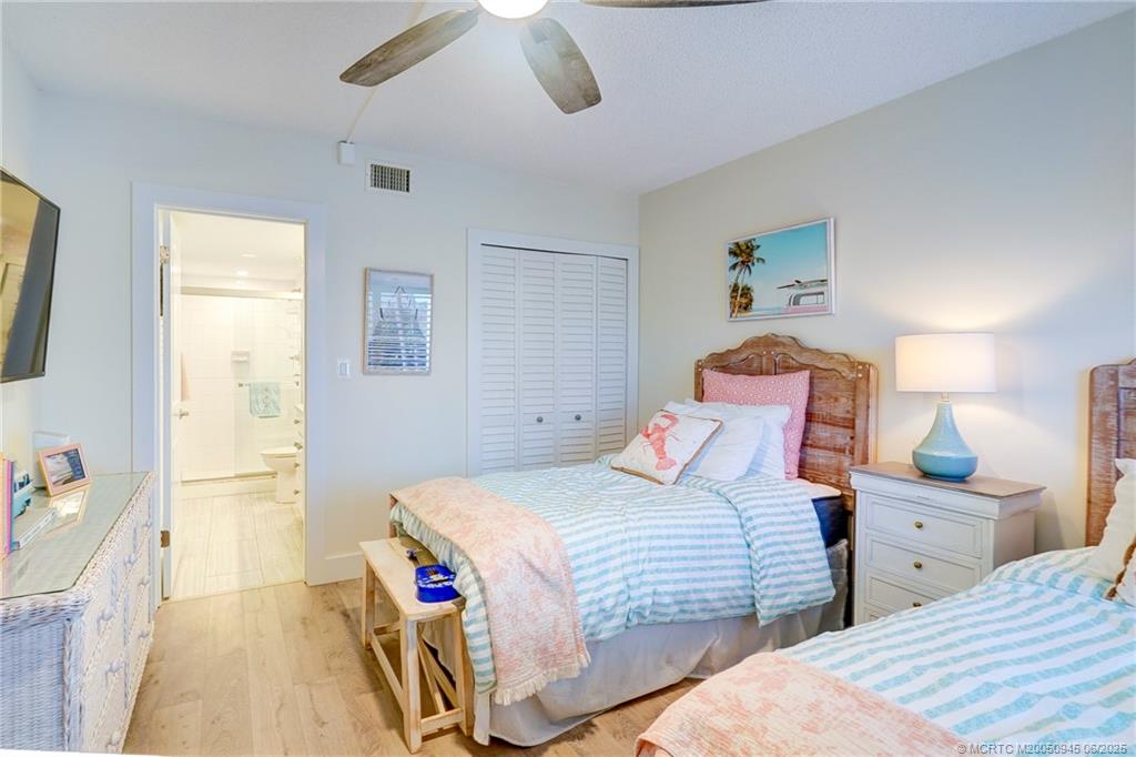 245 Northeast MacArthur Boulevard, Unit 11 Stuart, FL 34996 - Photo 10 of 47 a bedroom with two beds and a table