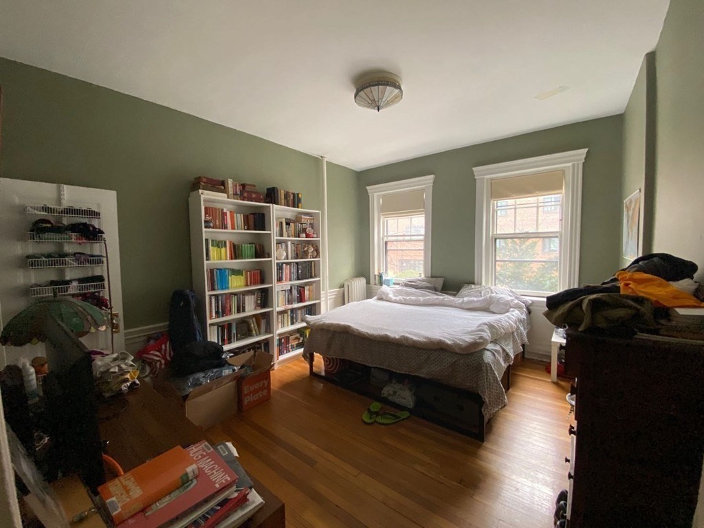 70 Strathmore Road, Unit 2B Boston, MA 02135 - Photo 4 of 7 a bedroom with a bed a dresser and a book shelf