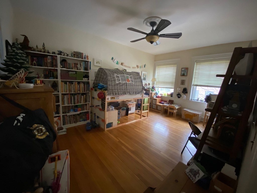 70 Strathmore Road, Unit 2B Boston, MA 02135 - Photo 5 of 7 a living room with lots of furniture and a book shelf