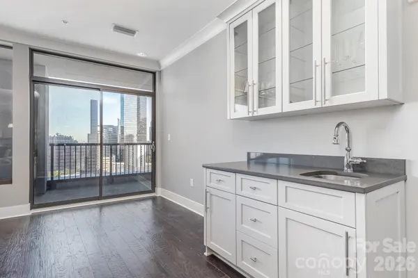 a kitchen with granite countertop a sink and cabinets