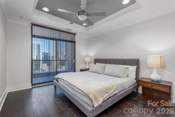 a bedroom with a bed and a night stand