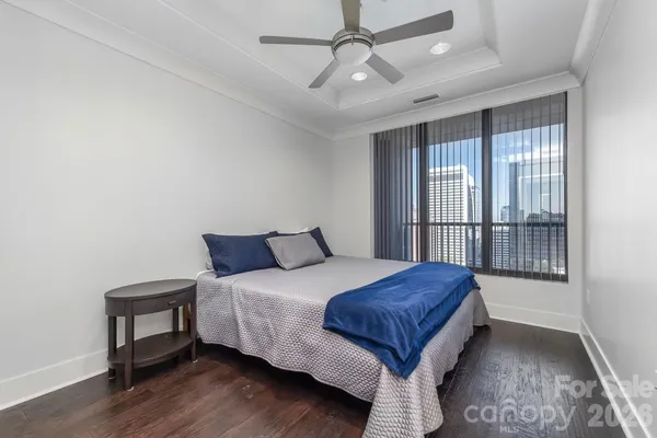 a spacious bedroom with a bed and a window