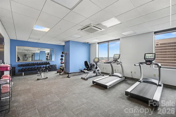 a room with gym equipment and a table